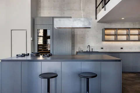 a kitchen with stainless steel appliances granite countertop a sink a stove and a refrigerator