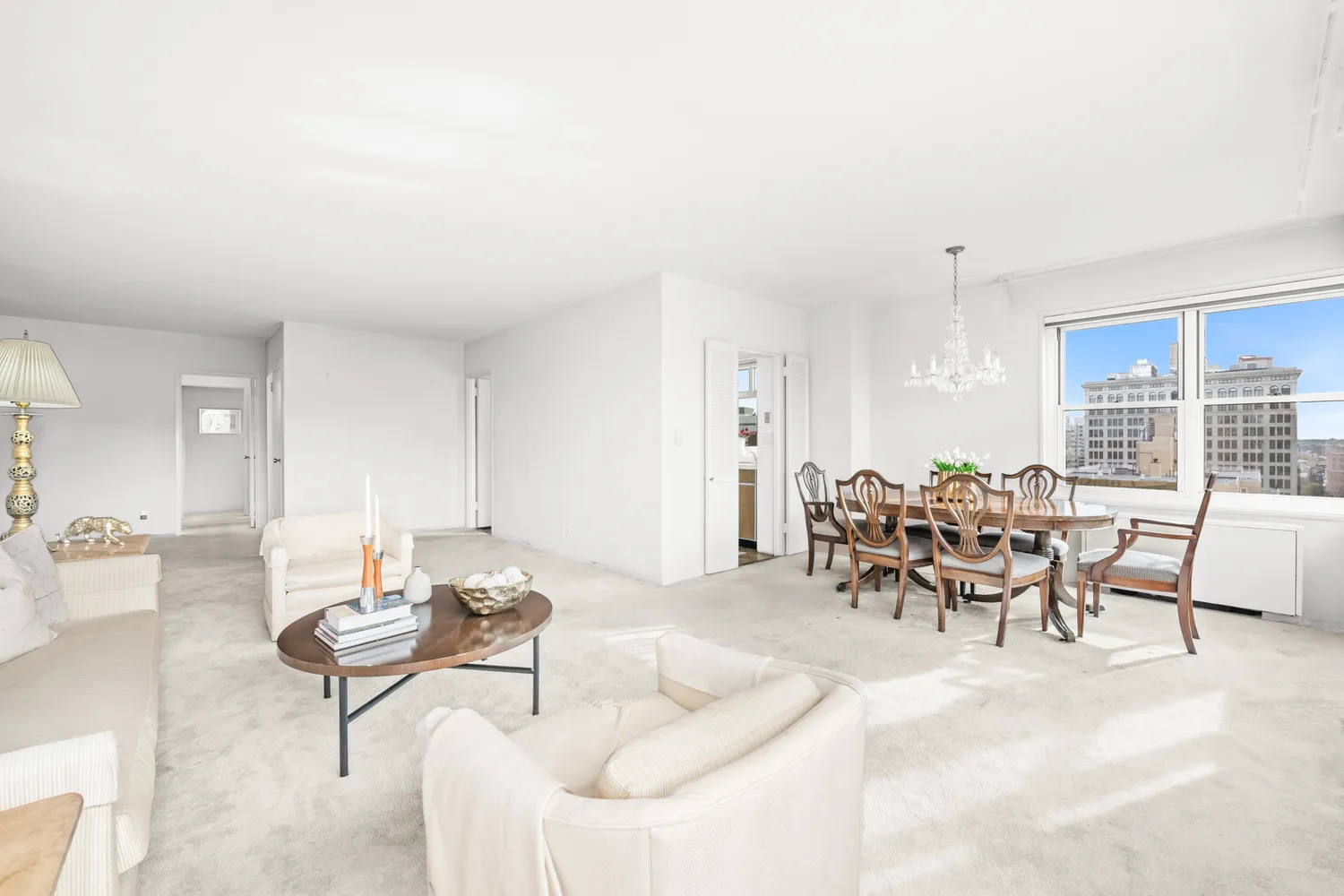 a dining room with furniture and a large window