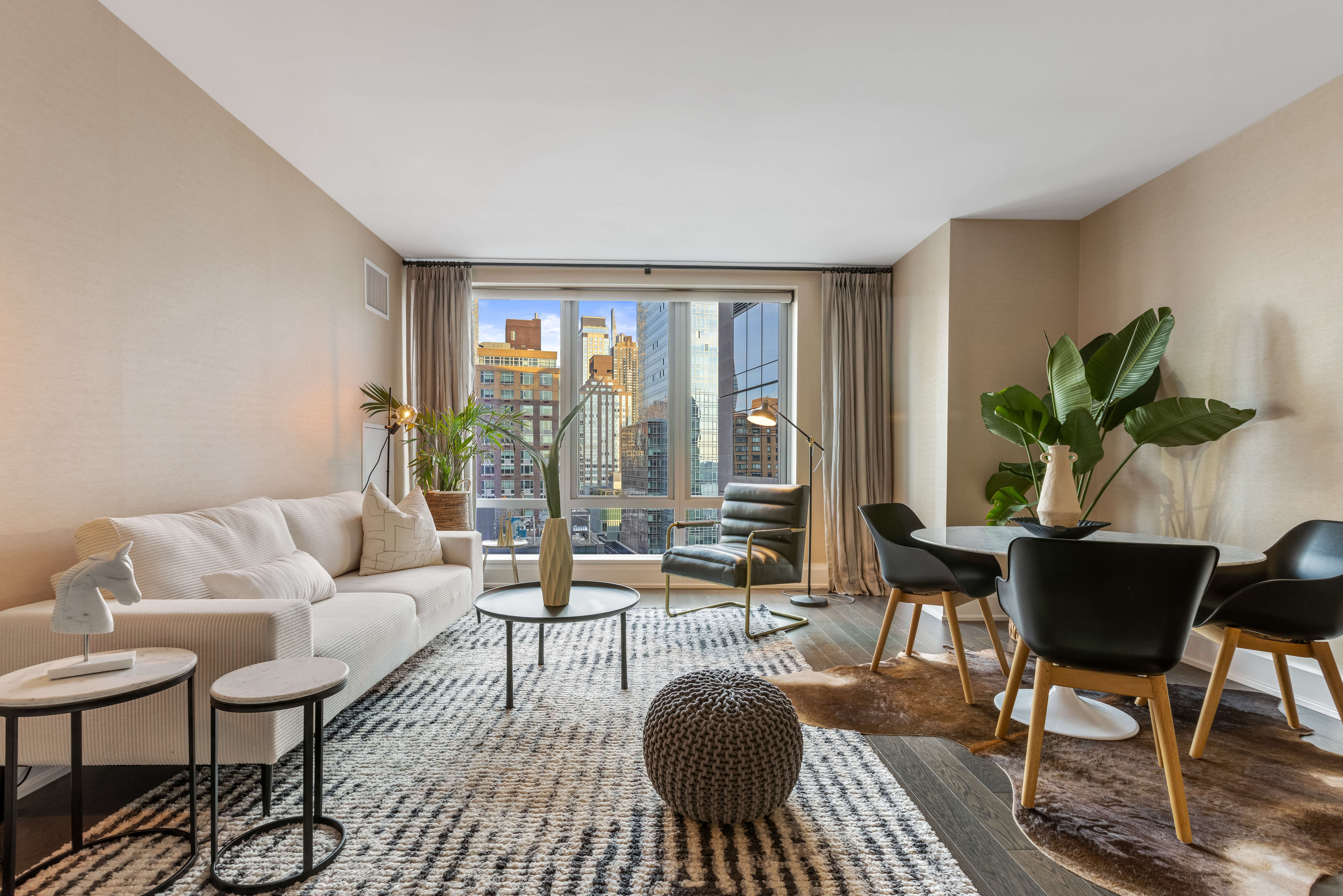 50 Riverside Boulevard, Unit 19F Manhattan, NY 10069 - Photo 2 of 24 a living room with furniture and a large window