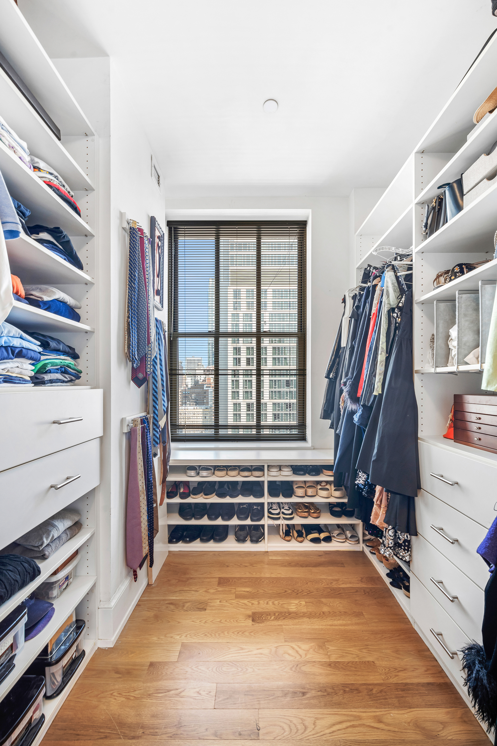 130 West 30th Street, Unit 16A Manhattan, NY 10001 - Photo 8 of 17 a view of walk in closet with clothes and shoes
