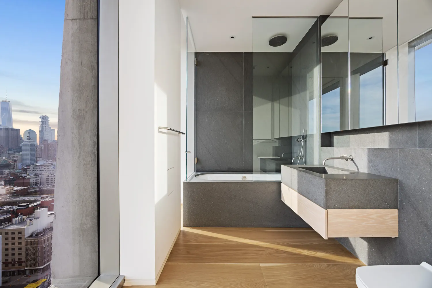 a living room with stainless steel appliances kitchen island granite countertop a refrigerator and a sink