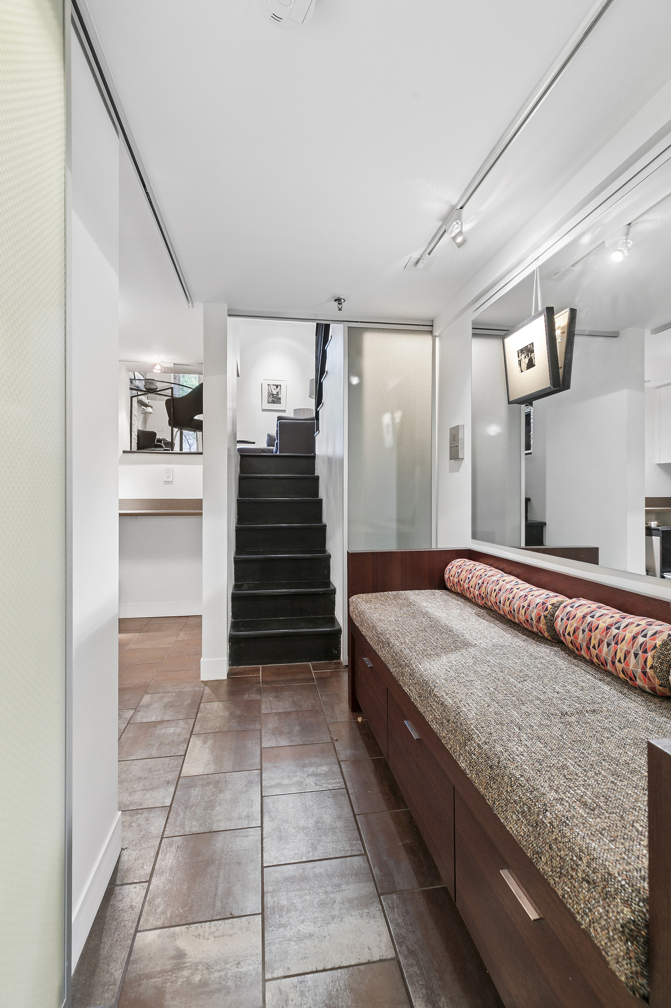 133 East 15th Street, Unit 1B Manhattan, NY 10003 - Photo 9 of 12 a spacious bathroom with a granite countertop sink and a mirror