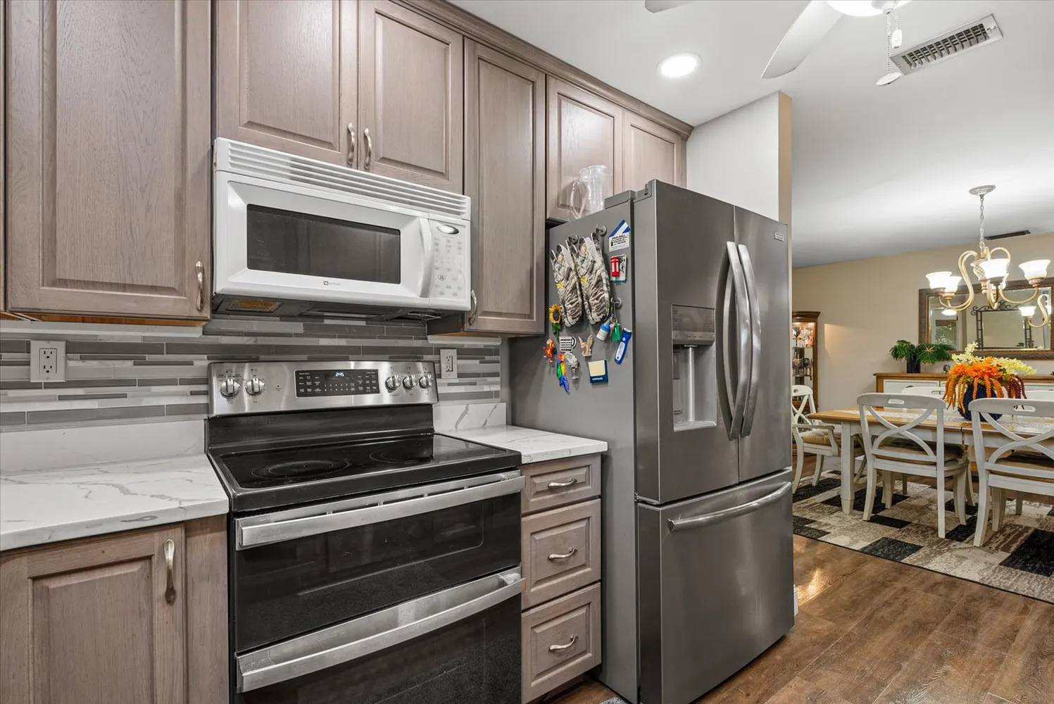 a kitchen with stainless steel appliances granite countertop a sink and cabinets