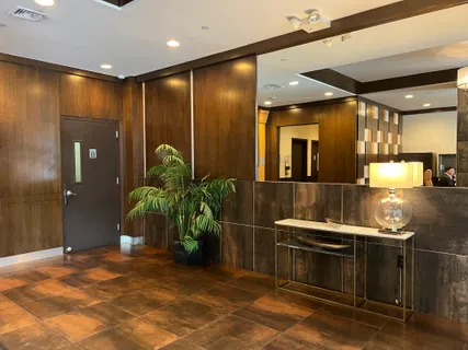 a kitchen with stainless steel appliances kitchen island granite countertop a refrigerator and a sink