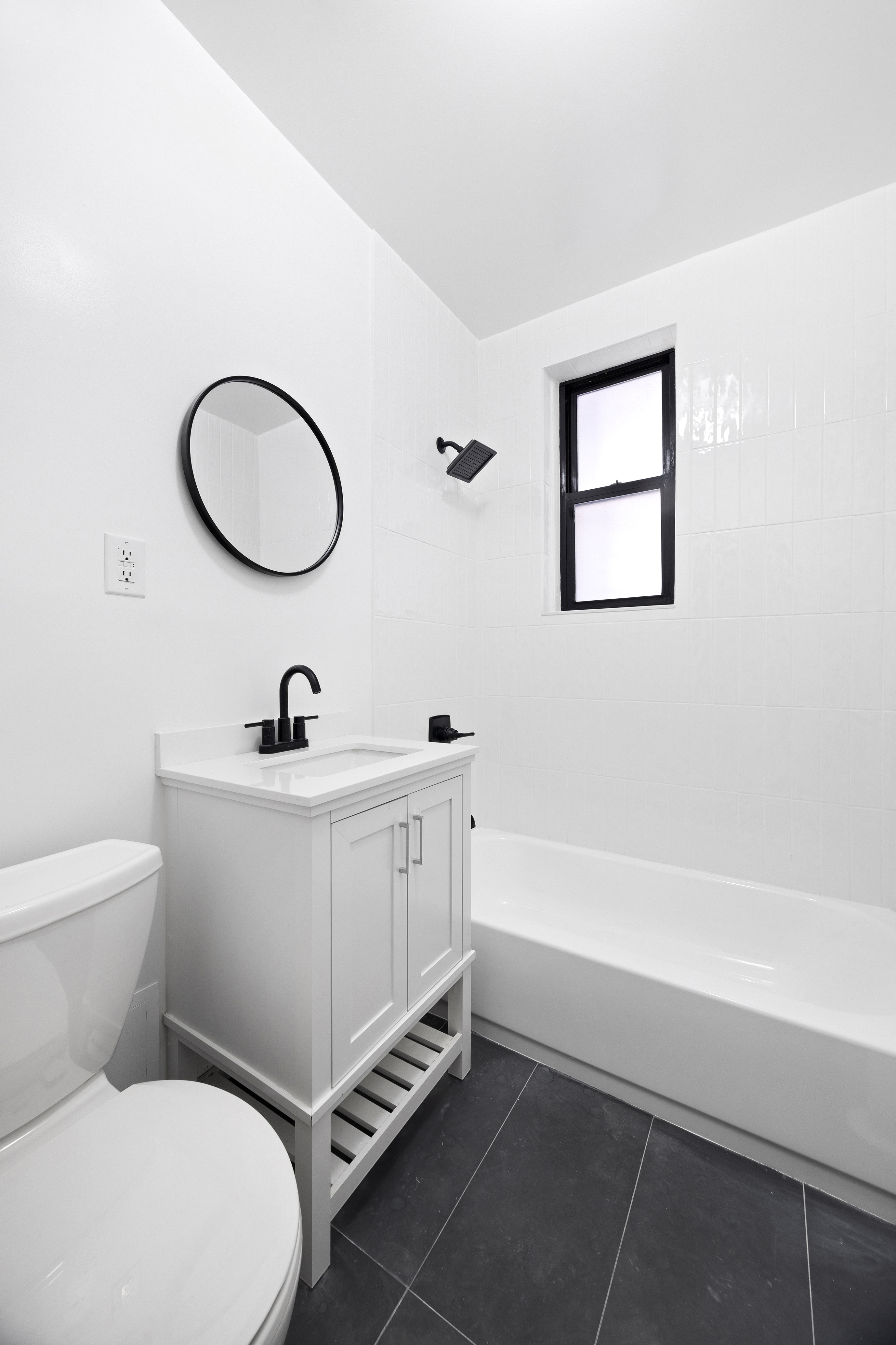 48 West 138th Street, Unit 2F Manhattan, NY 10037 - Photo 4 of 10 a bathroom with a toilet a sink and mirror
