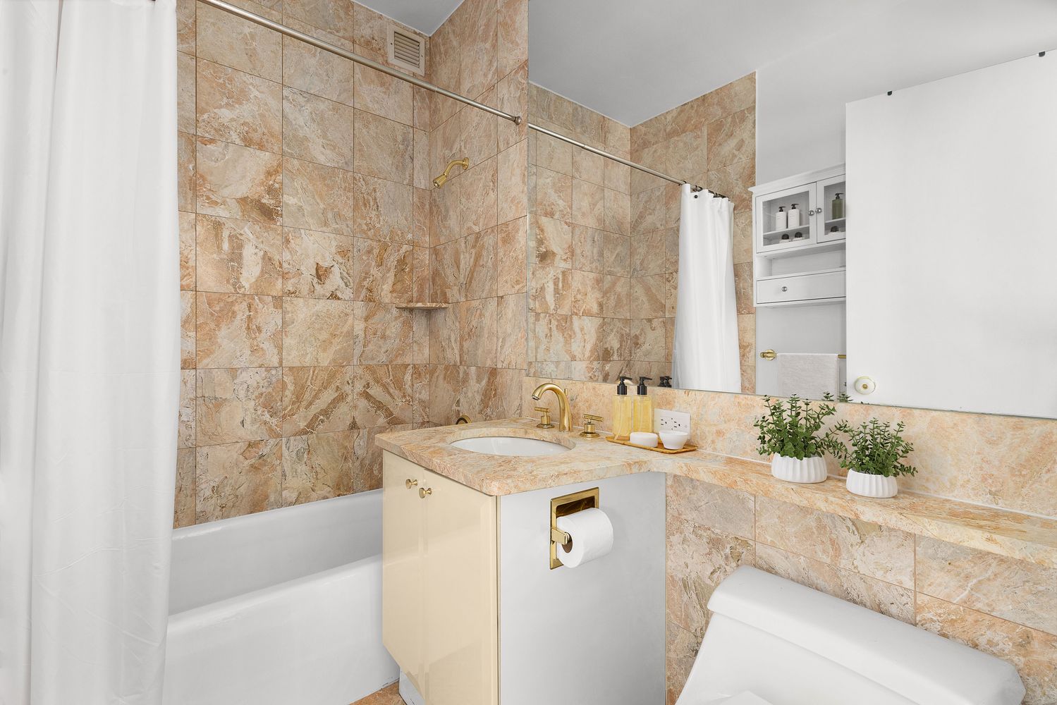 a bathroom with a granite countertop sink a mirror and a bathtub