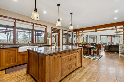 a kitchen with stainless steel appliances granite countertop a stove and a wooden floors