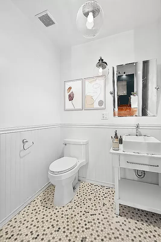 180 Bainbridge Street, Unit 401 Brooklyn, NY 11233 - Photo 7 of 23 a bathroom with a sink a toilet and mirror