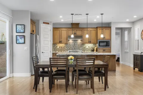 a large kitchen with stainless steel appliances kitchen island granite countertop a sink and cabinets