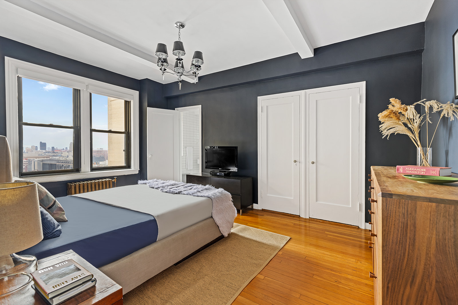 135 Eastern Parkway, Unit 13E Brooklyn, NY 11238 - Photo 9 of 15 a spacious bedroom with a bed and a chandelier