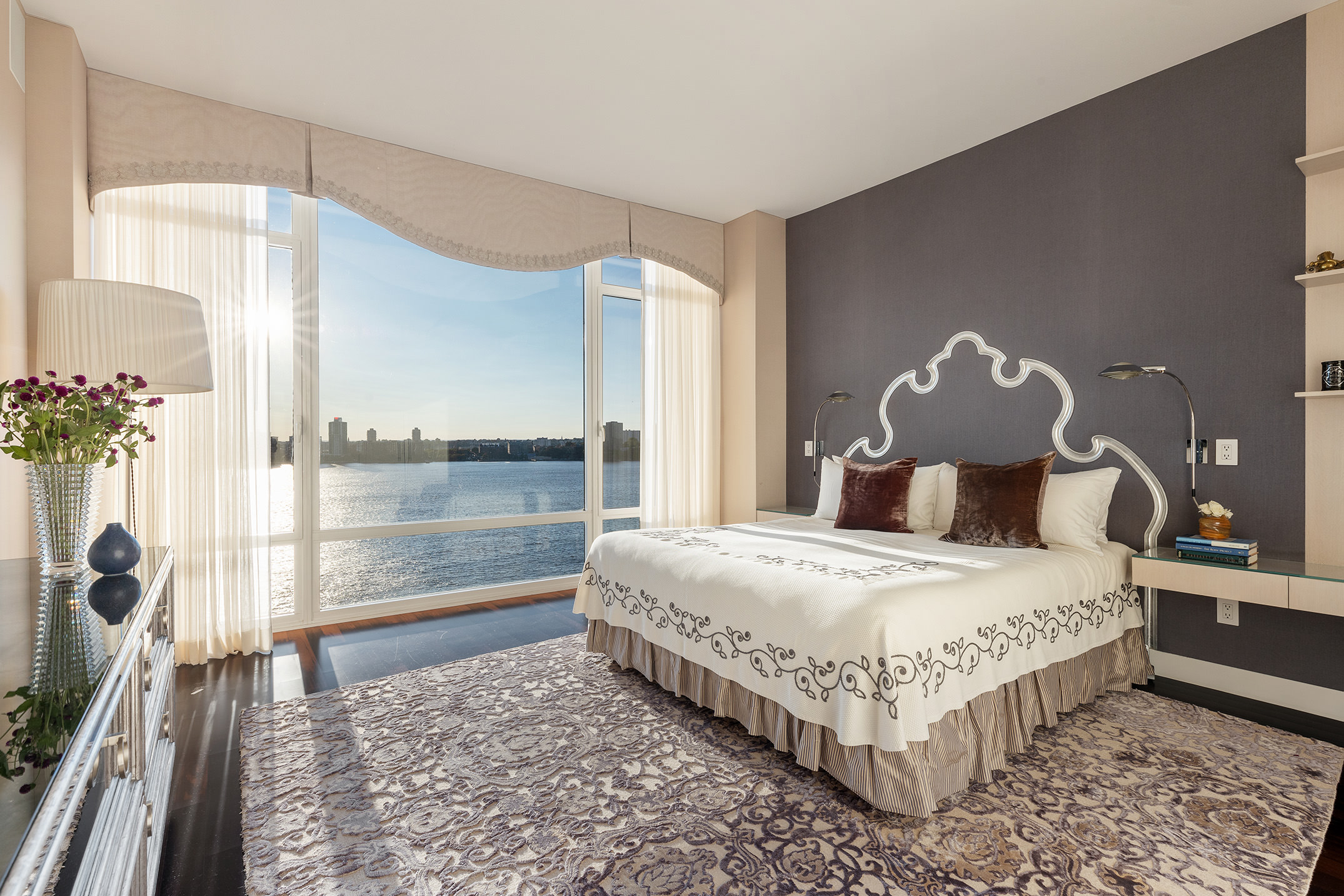 400 West 12th Street, Unit 12C Manhattan, NY 10014 - Photo 10 of 24 a bedroom with a large bed and a chandelier