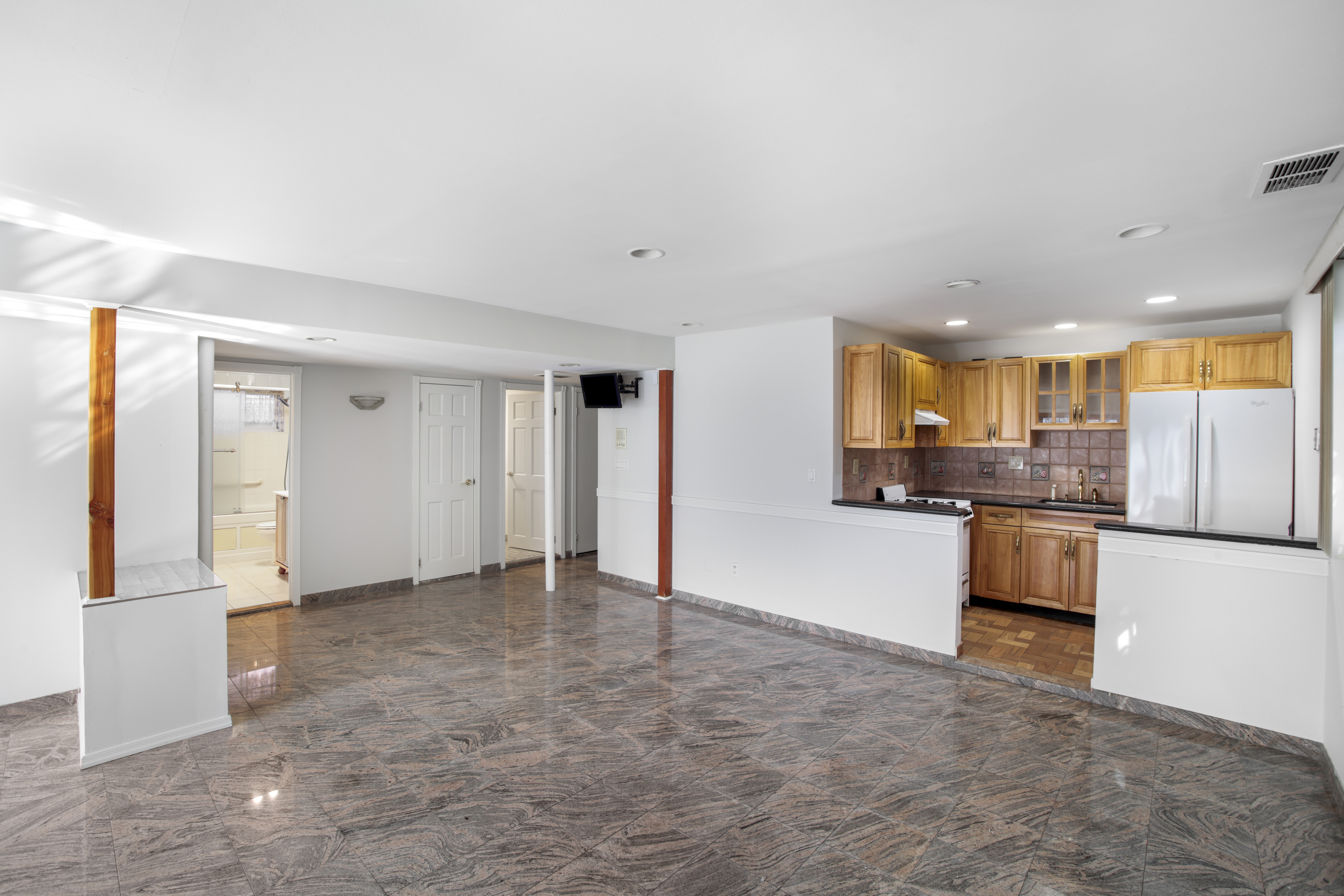 60 82nd Street Brooklyn, NY 11209 - Photo 15 of 19 a view of a kitchen with refrigerator and white cabinets