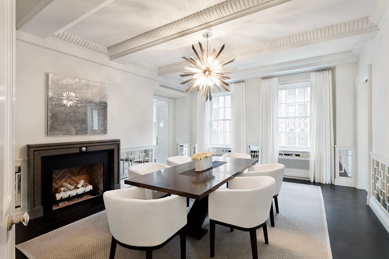 a dining room with furniture a fireplace and wooden floor