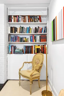 a living room with lots of books and a book shelf