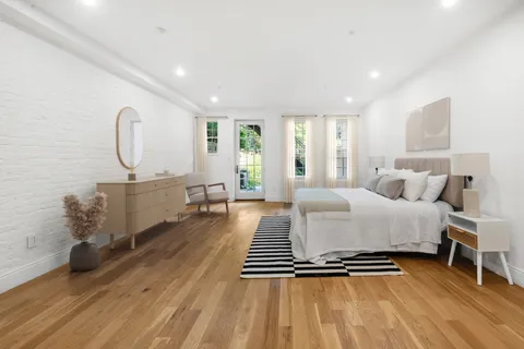 a bedroom with furniture and a wooden floor