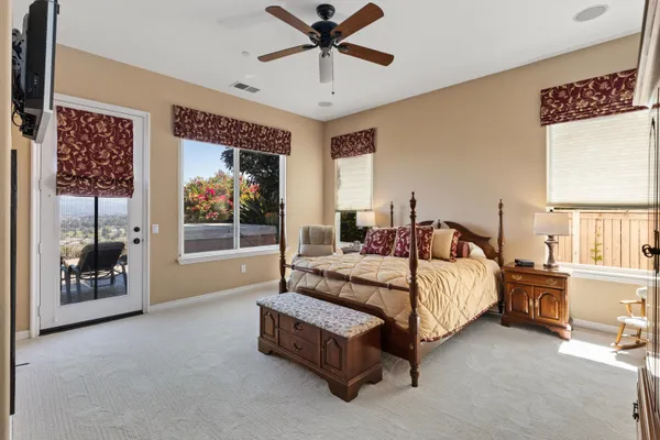 a bedroom with a bed and a television