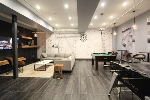 a living room with furniture a wooden floor and a flat screen tv