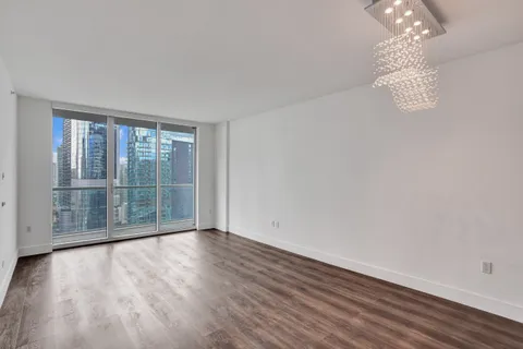 a view of a room with wooden floor and fan
