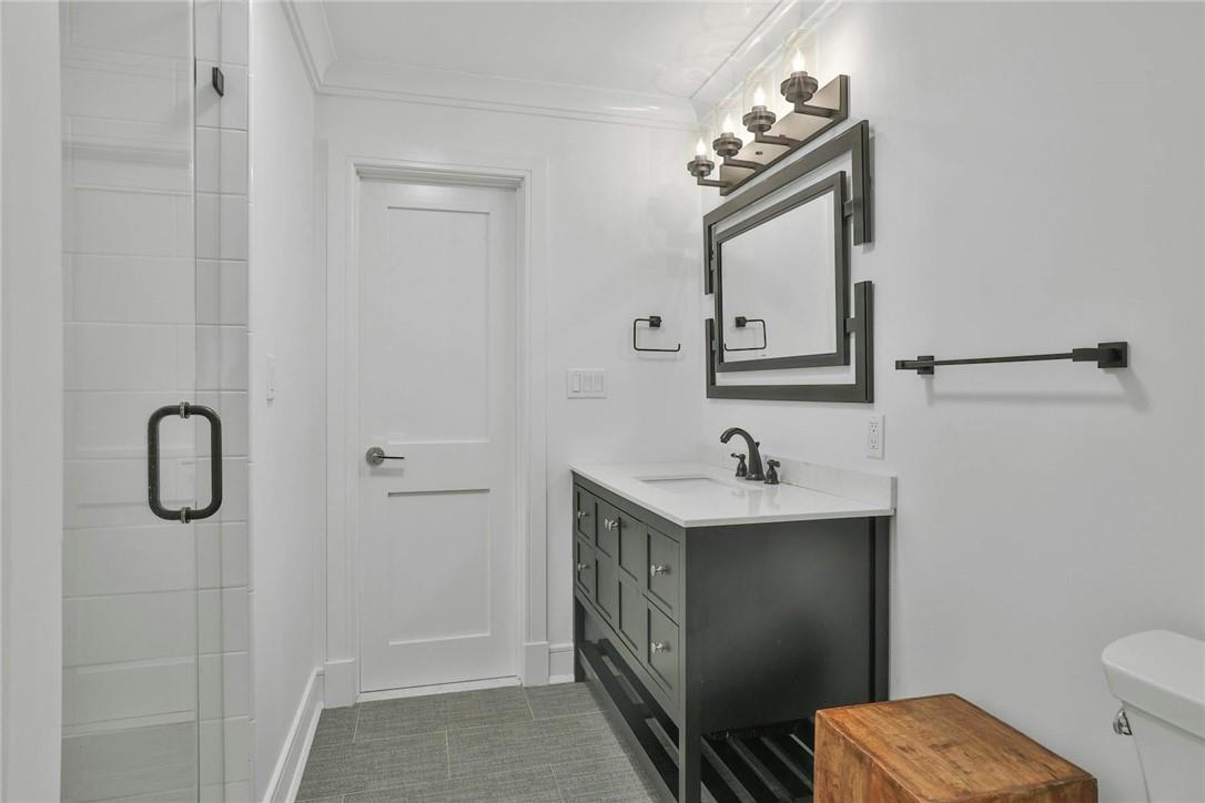 211 Purchase Street, Unit A Rye, NY 10580 - Photo 19 of 22 a bathroom with a sink a toilet and mirror