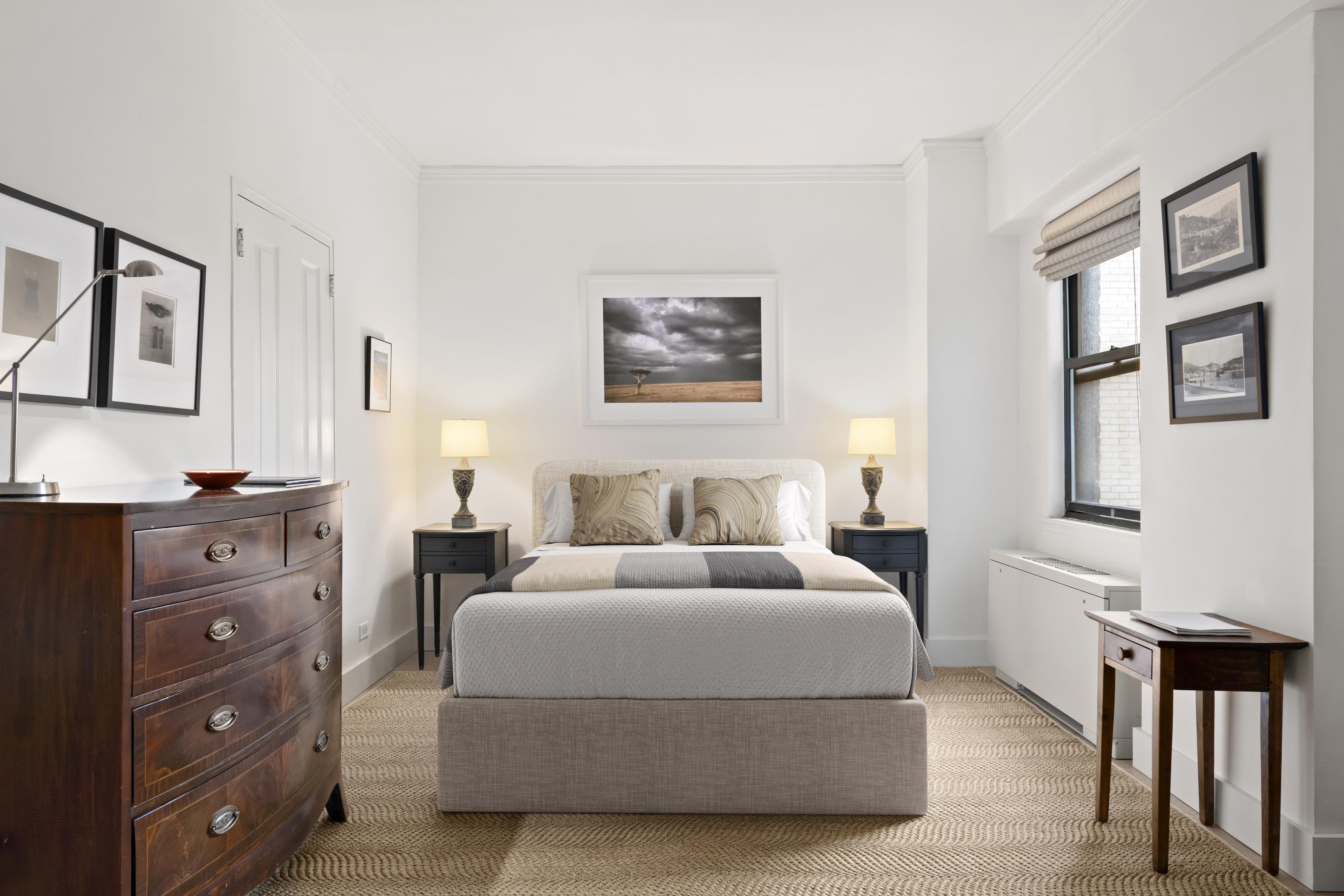 201 East 21st Street, Unit 12M Manhattan, NY 10010 - Photo 6 of 10 a bedroom with a bed and a dresser