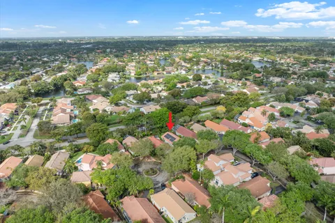 a view of a yard with plants and trees