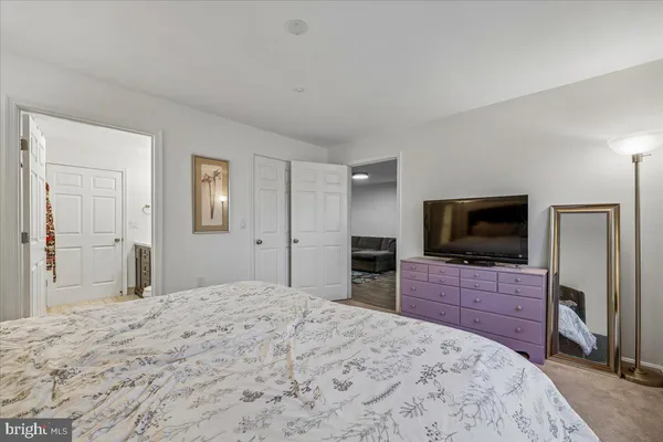 a bedroom with a bed and a flat screen tv in it