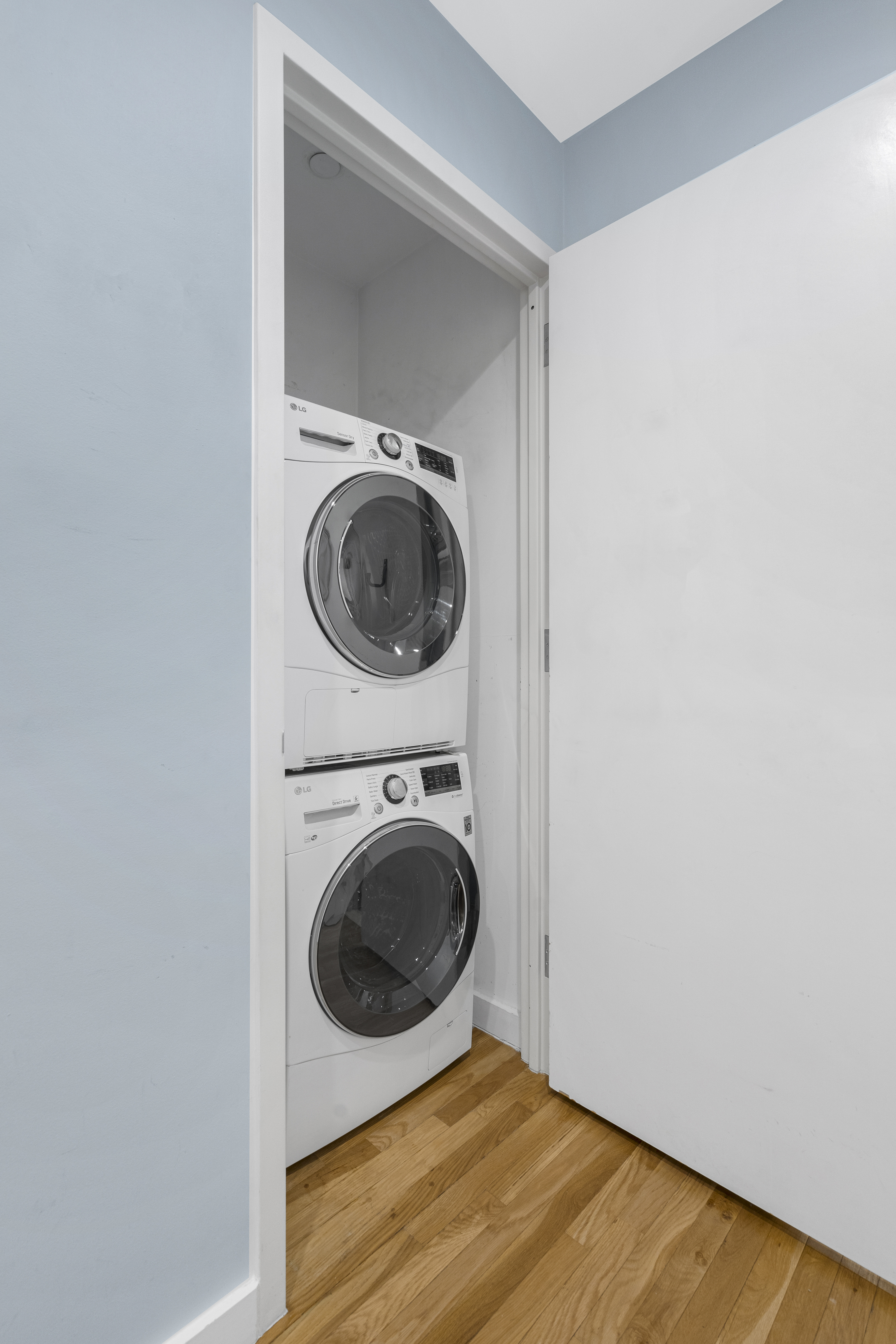 333 East 109th Street, Unit 2A Manhattan, NY 10029 - Photo 6 of 13 a view of a hallway with washer and dryer