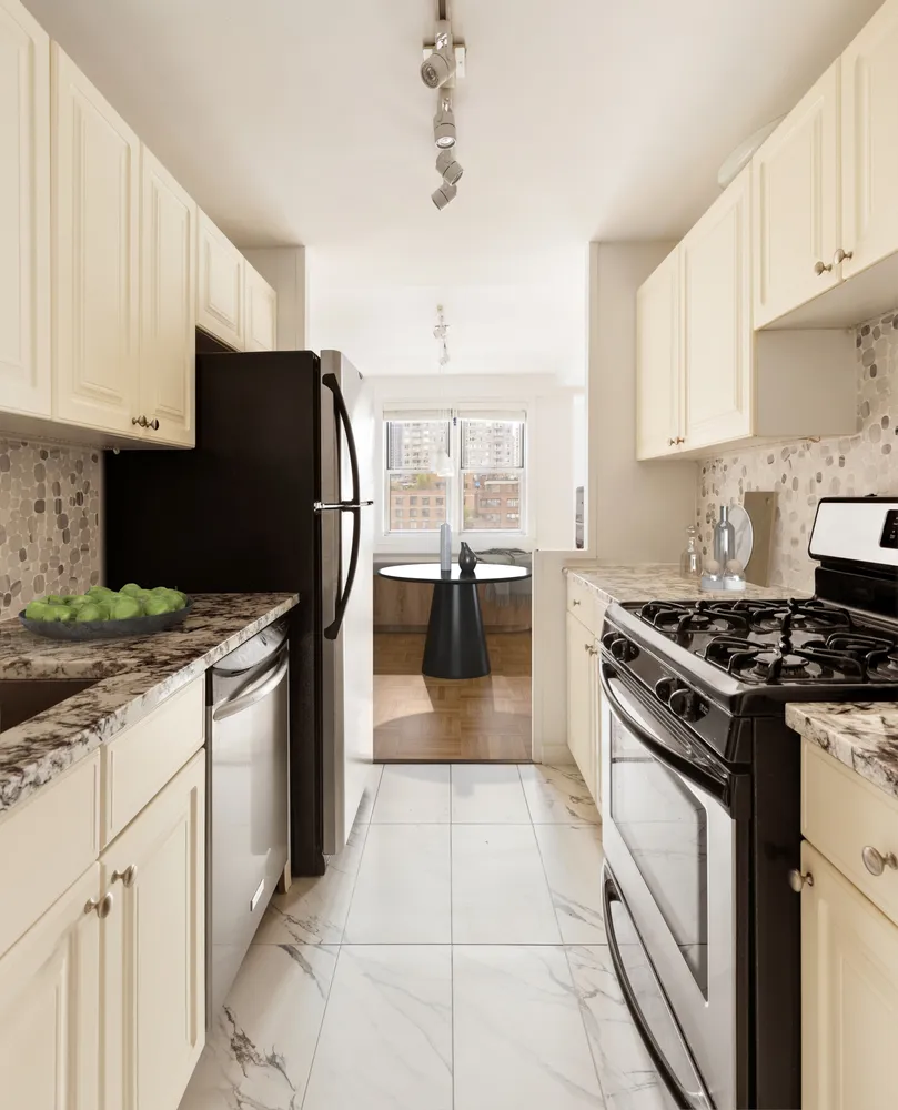 a kitchen with granite countertop a stove top oven a sink a counter space and cabinets