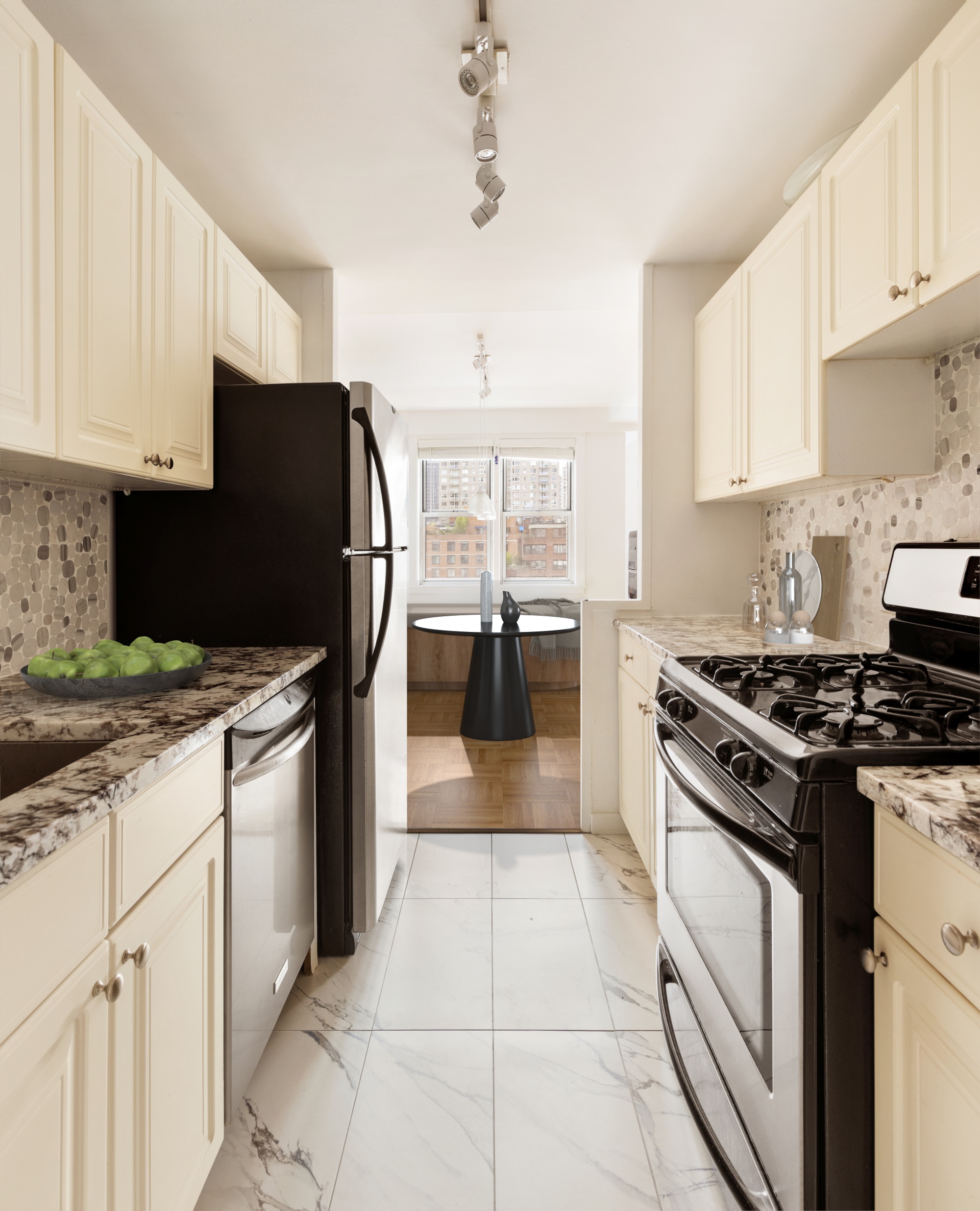 525 East 82nd Street, Unit 12E Manhattan, NY 10028 - Photo 11 of 29 a kitchen with granite countertop a stove top oven a sink a counter space and cabinets