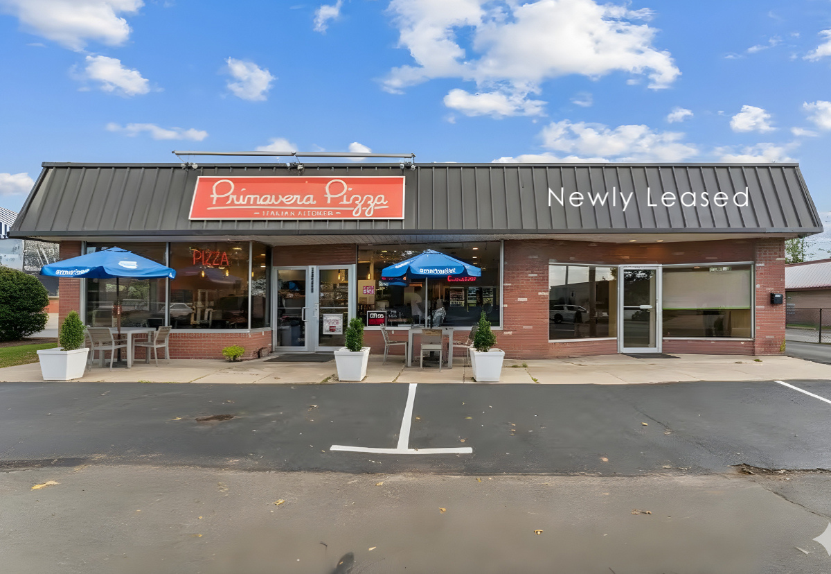 13500 Main Road Mattituck, NY 11952 - Photo 2 of 10 a man sitting on a bench in front of a building