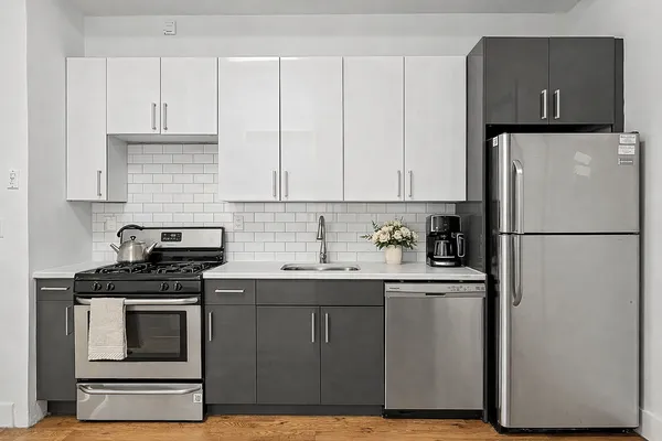 a kitchen with a sink stove and refrigerator