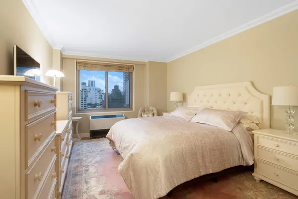 a bedroom with a large bed and a window