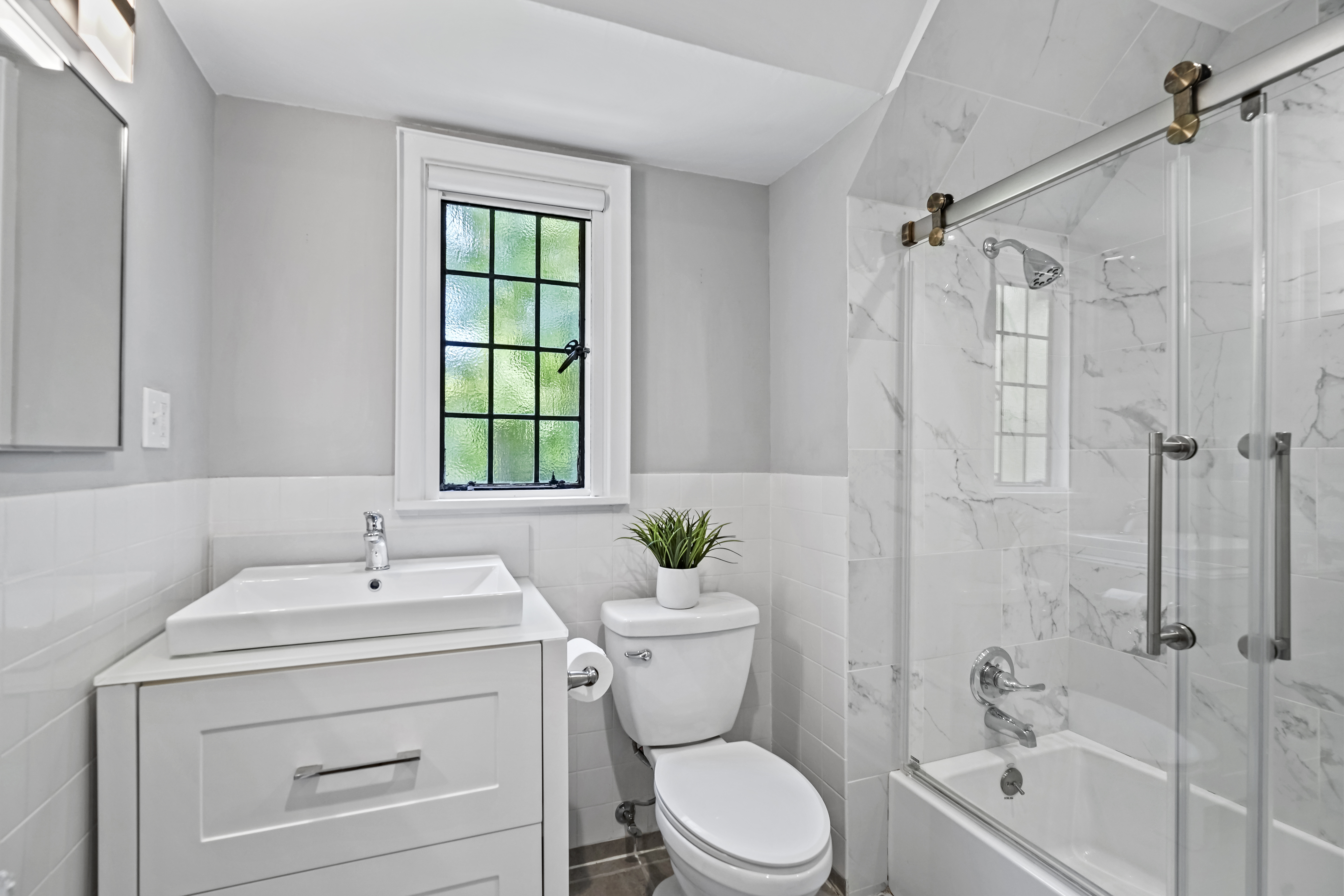 19 Avon Road Larchmont, NY 10538 - Photo 18 of 35 a bathroom with a sink a toilet and shower