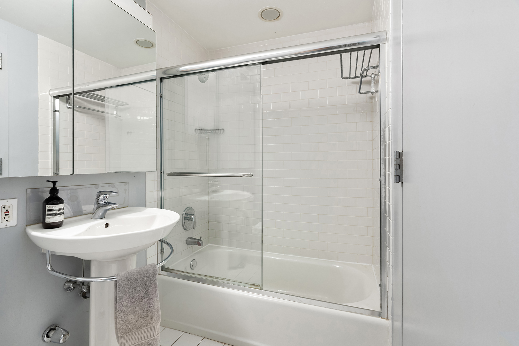 242 East 25th Street, Unit 3A Manhattan, NY 10010 - Photo 7 of 9 a bathroom with a sink and a mirror