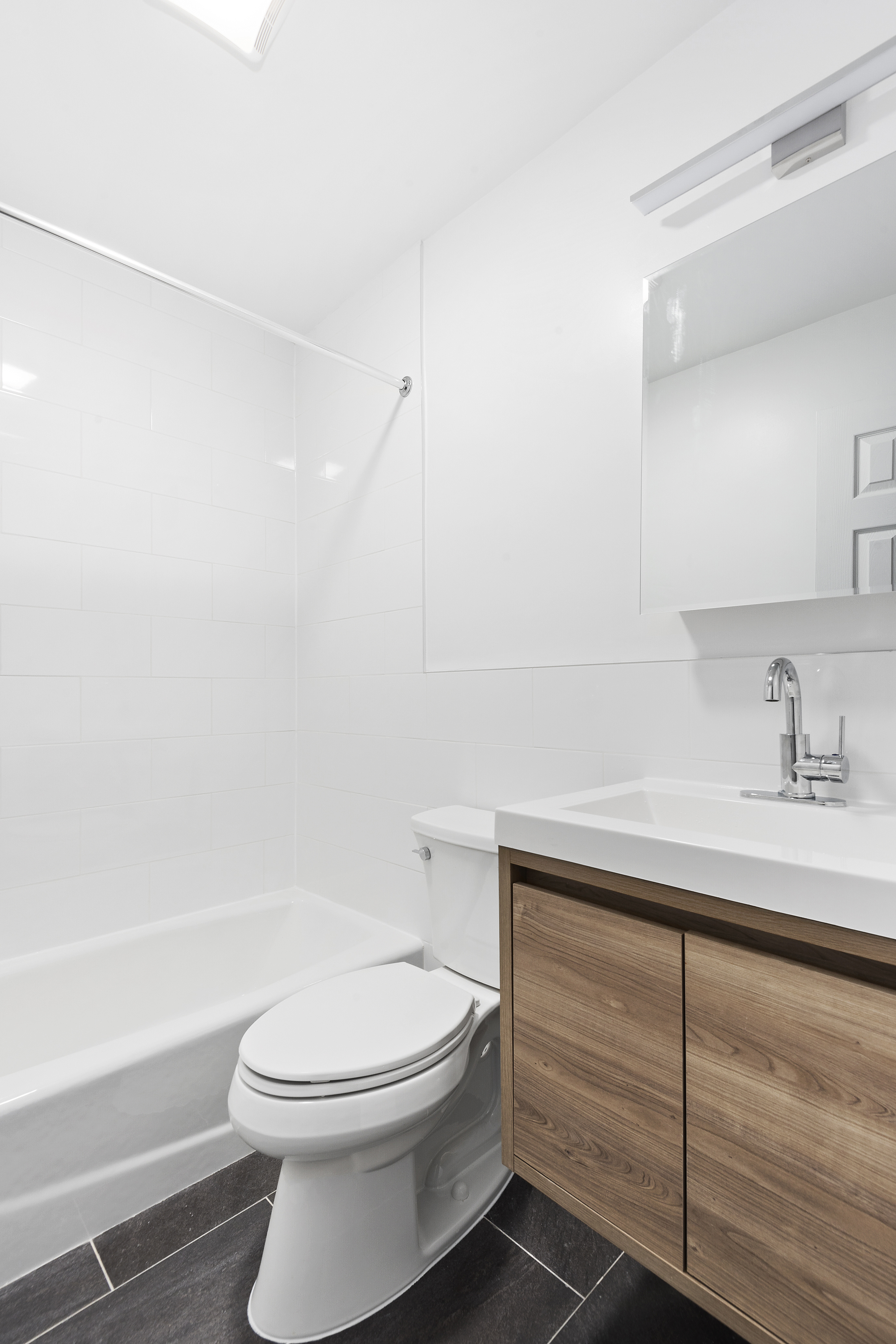 59 Stagg Street, Unit 3 Brooklyn, NY 11206 - Photo 6 of 8 a bathroom with a sink a toilet and vanity