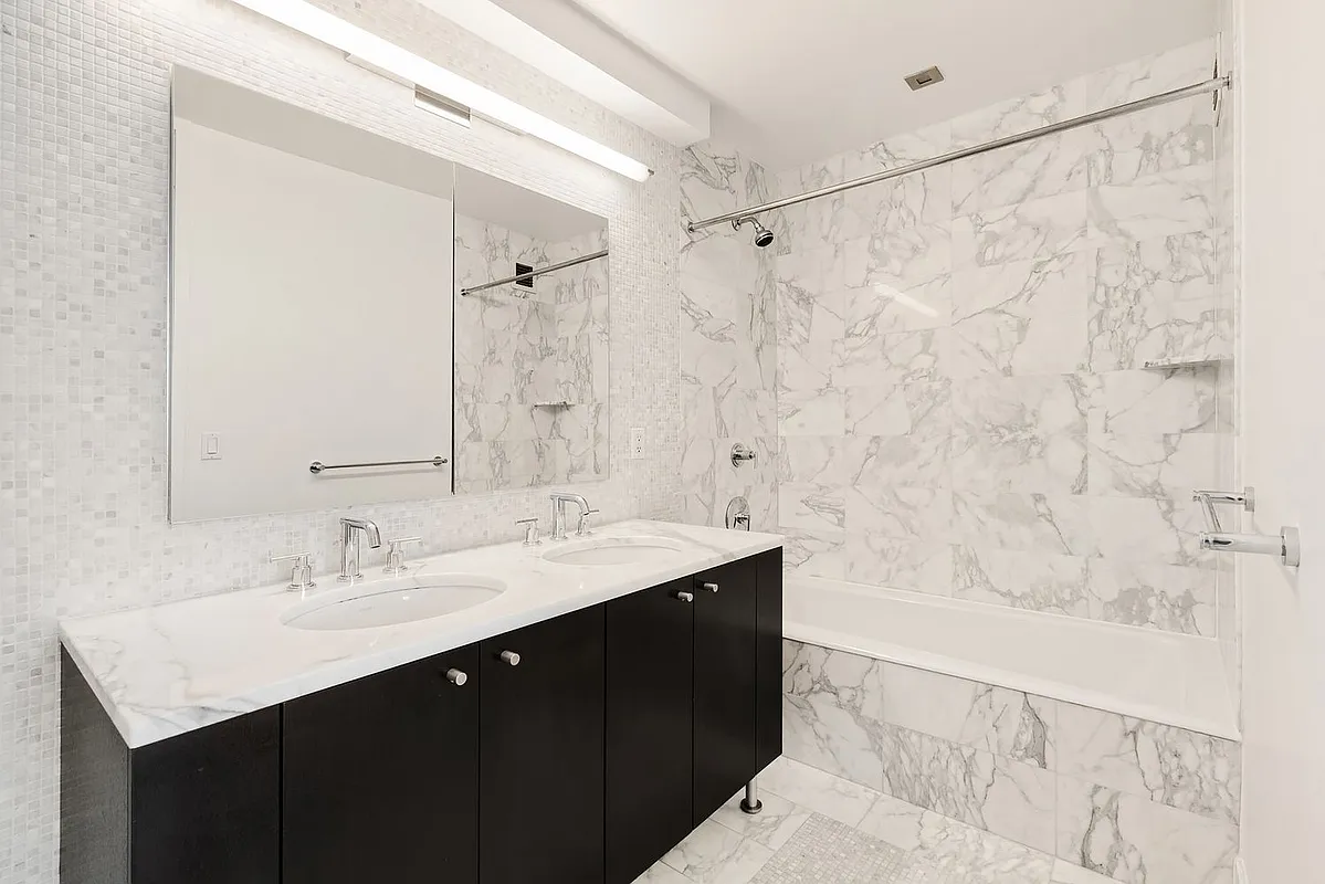 46-30 Center Boulevard, Unit 710 Queens, NY 11109 - Photo 9 of 25 a bathroom with a sink and a mirror