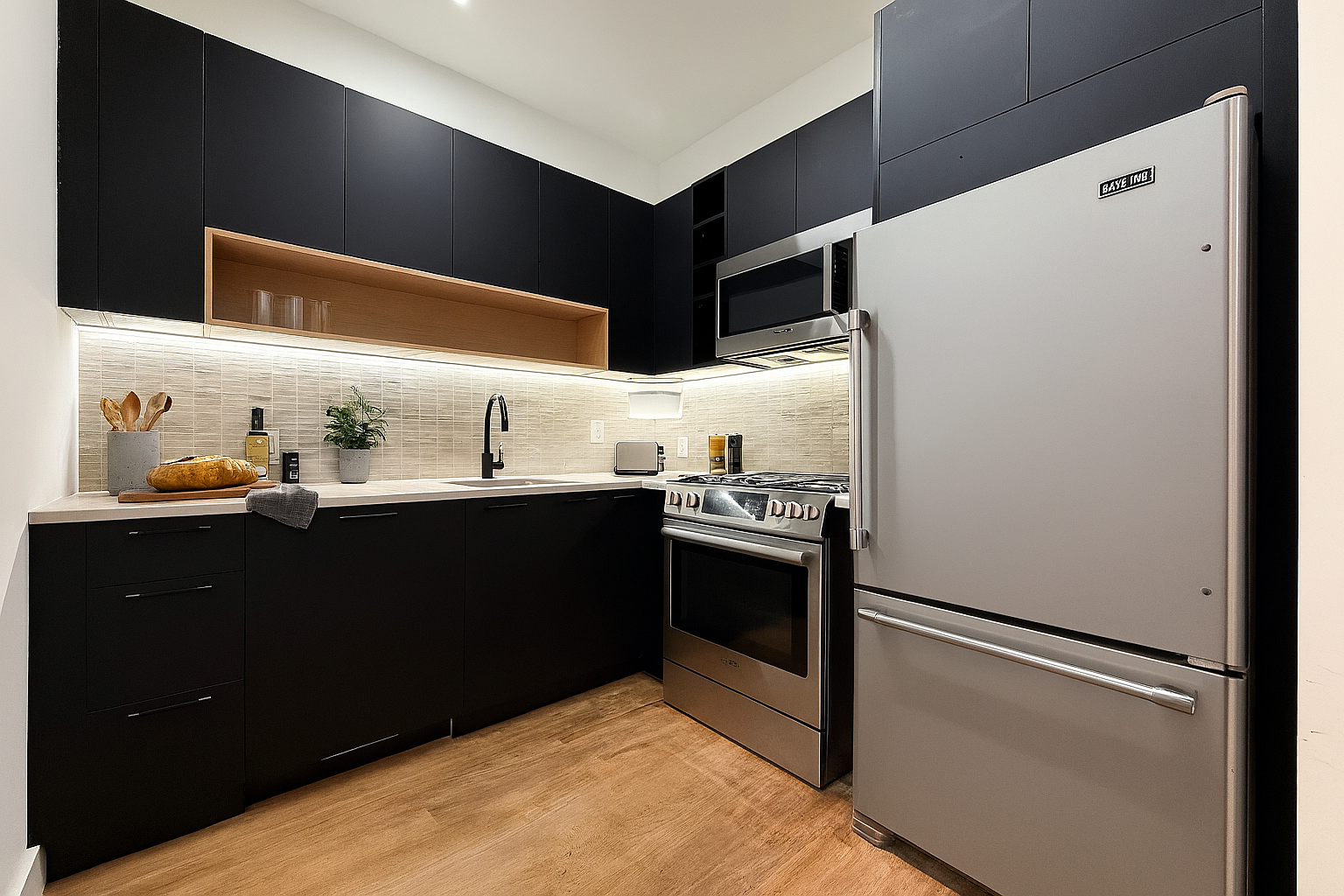 71 Cooper Street, Unit 2B Brooklyn, NY 11207 - Photo 2 of 4 a kitchen with stainless steel appliances granite countertop a refrigerator and a sink