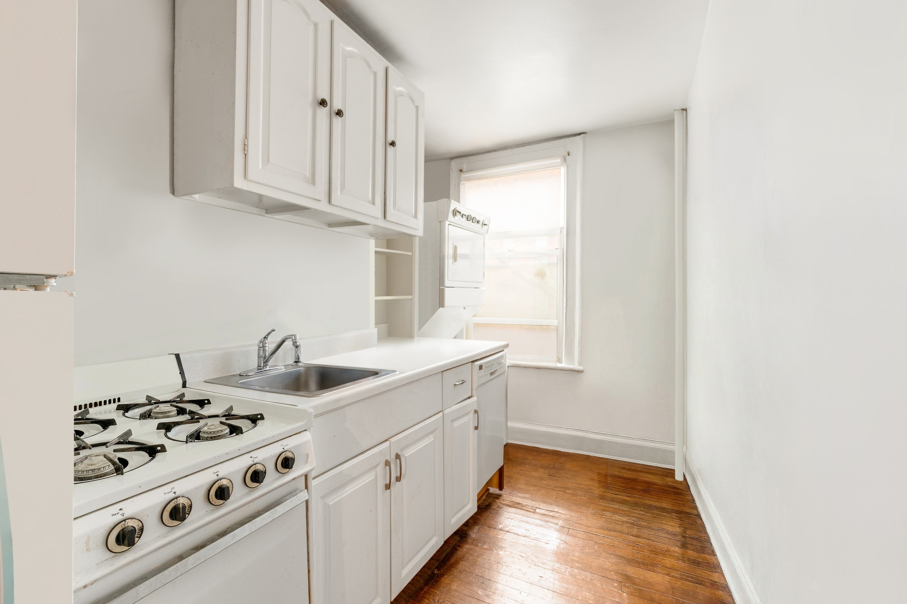 446 State Street Brooklyn, NY 11217 - Photo 13 of 23 a kitchen with white cabinets and white appliances