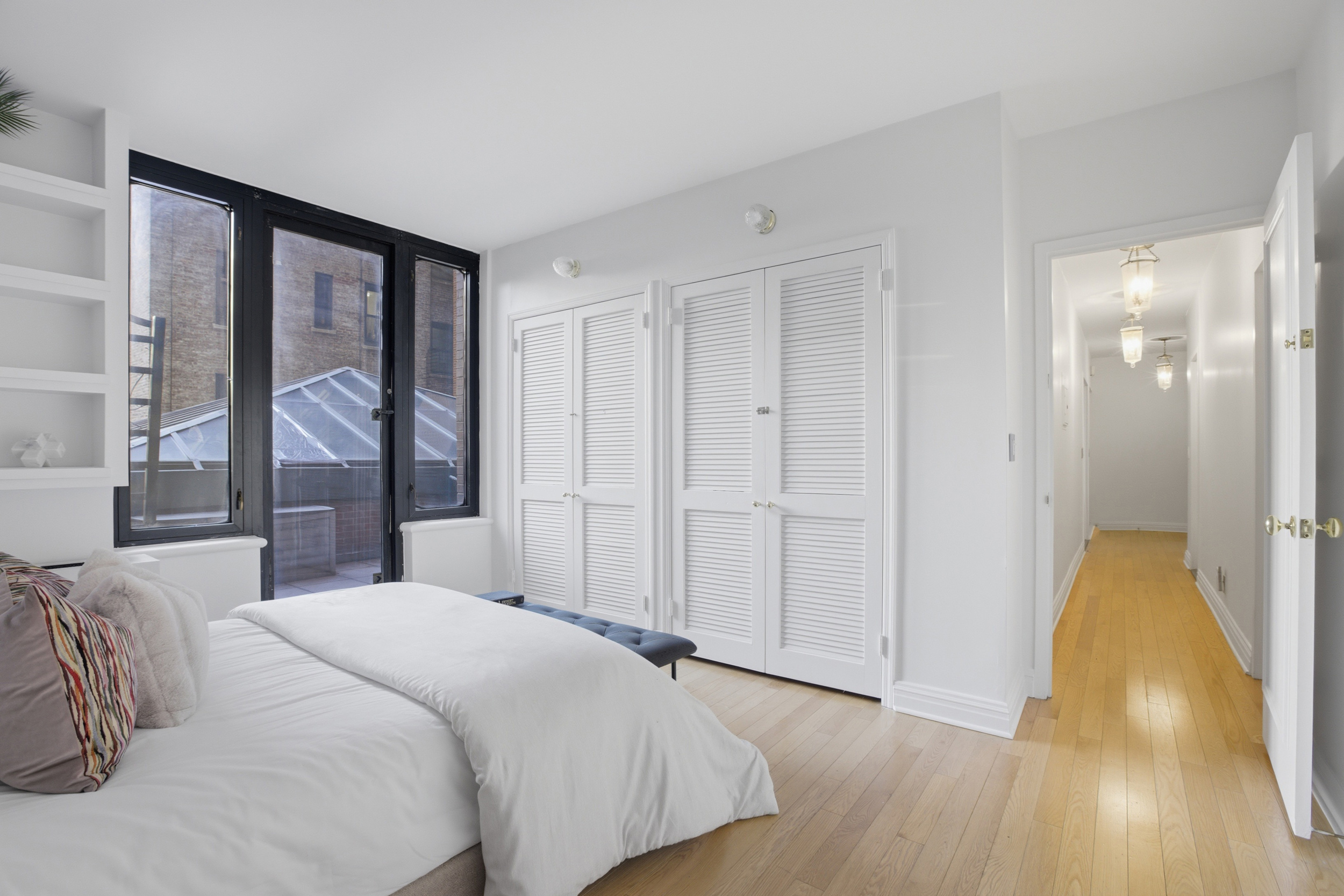 188 East 70th Street, Unit 3A Manhattan, NY 10021 - Photo 12 of 18 a bedroom with a bed and a large window