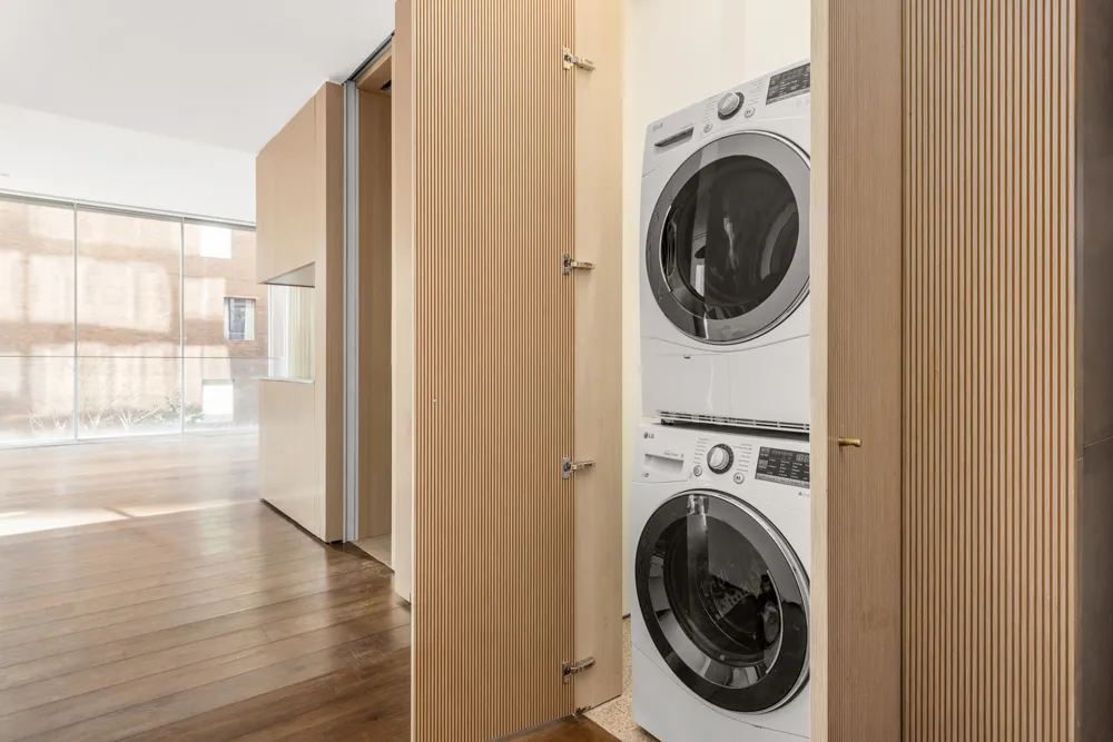 a view of a hallway with washer and dryer