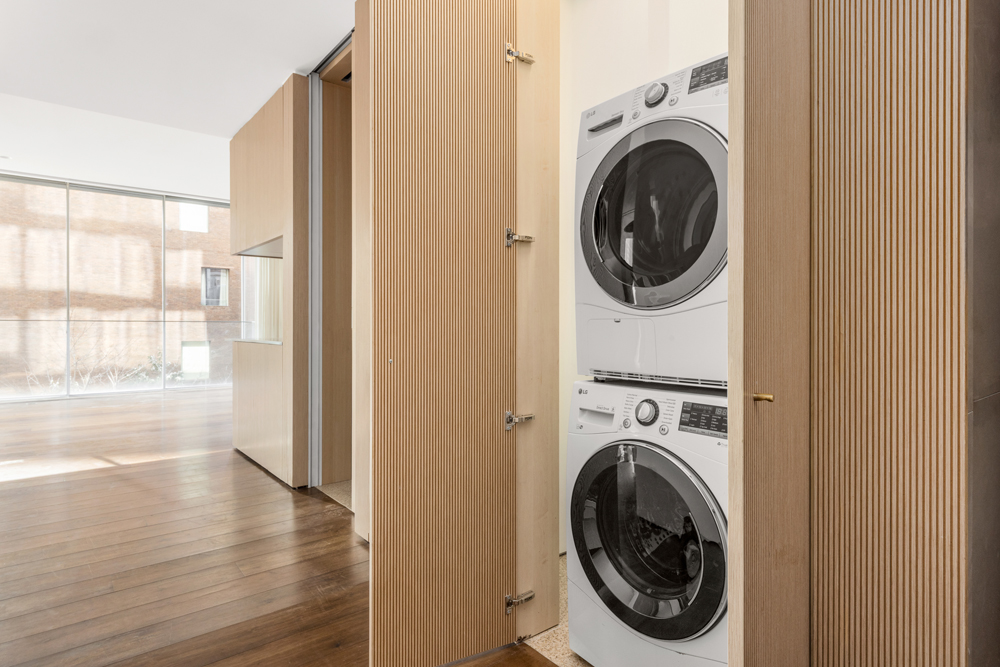 527 West 27th Street, Unit 3C Manhattan, NY 10001 - Photo 10 of 14 a view of a hallway with washer and dryer
