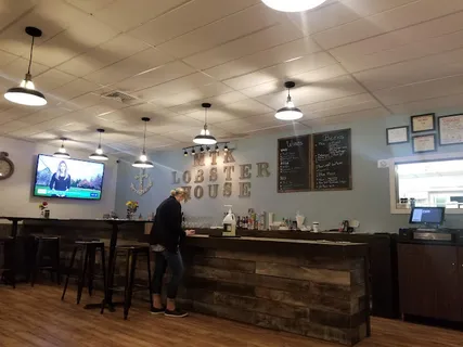 a view of a dining room with furniture wooden floor and a chandelier
