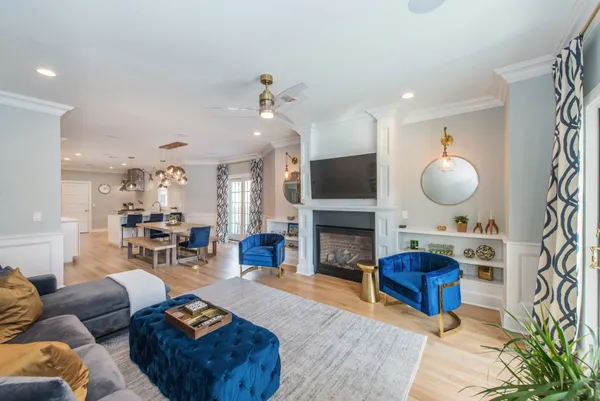 a living room with furniture a fireplace and a flat screen tv