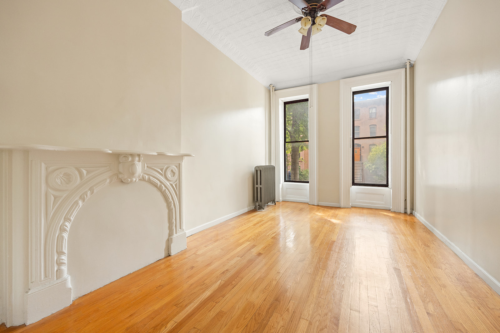 33 Park Place Brooklyn, NY 11217 - Photo 7 of 18 a view of a bedroom with wooden floor and fan