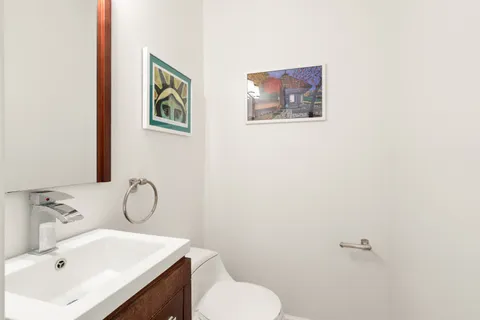 a bathroom with a sink mirror and toilet