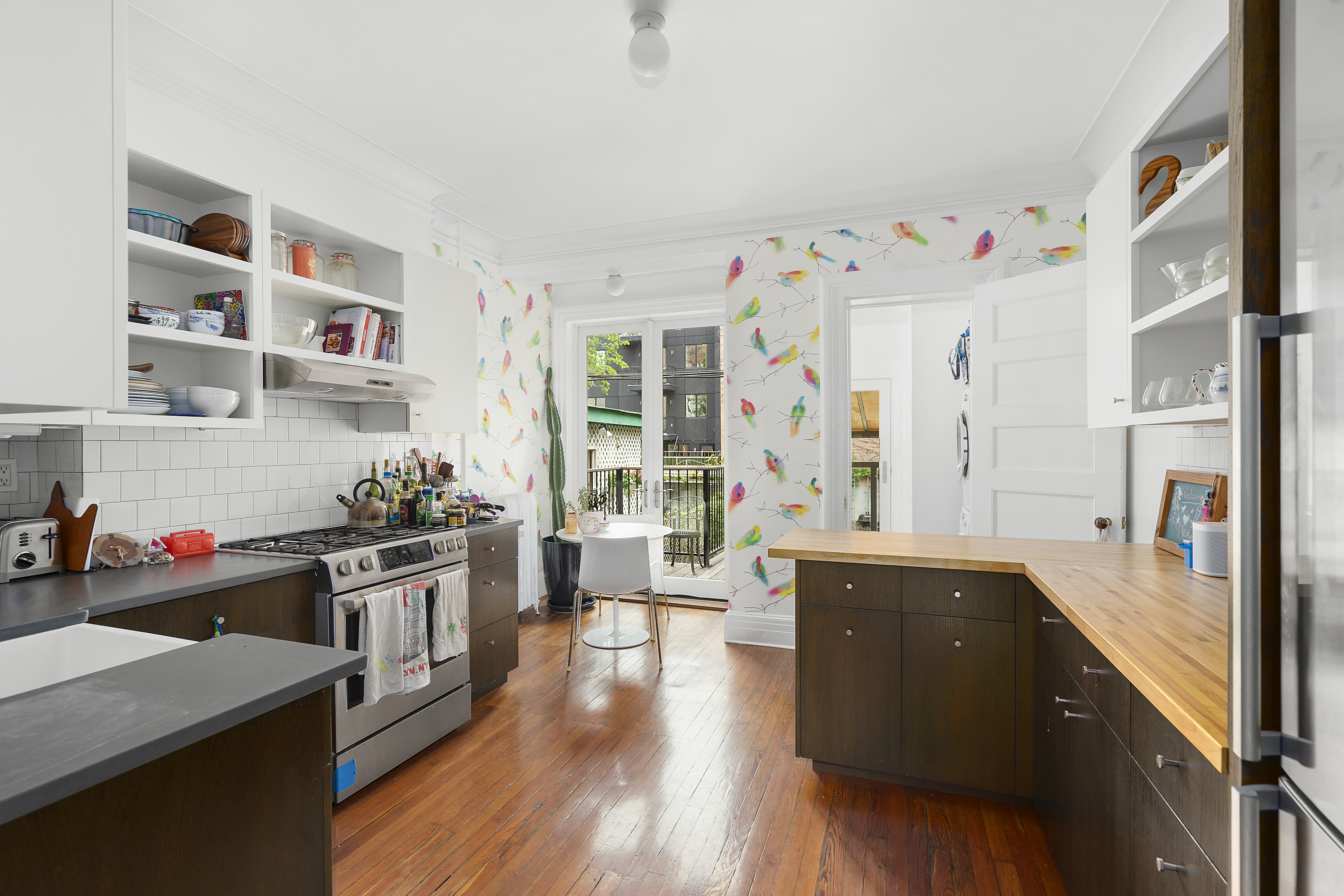 394 Lafayette Avenue, Unit 2 Brooklyn, NY 11238 - Photo 2 of 13 a kitchen with stainless steel appliances a stove a sink and wooden floor