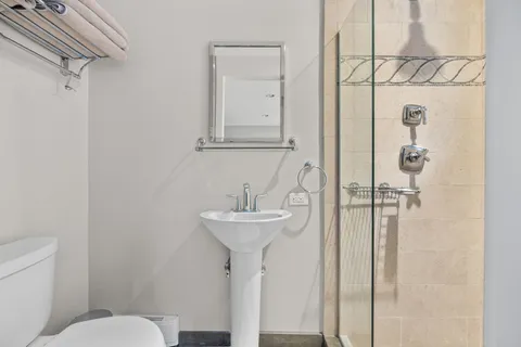 a front view of a building with lot of cars and trees