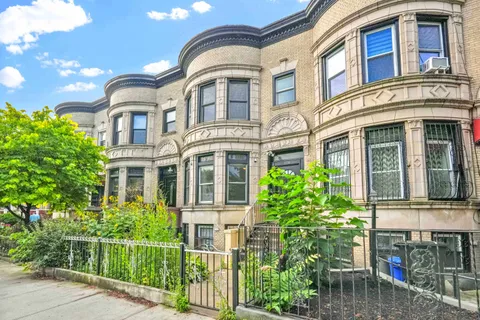 front view of a brick house with a large windows