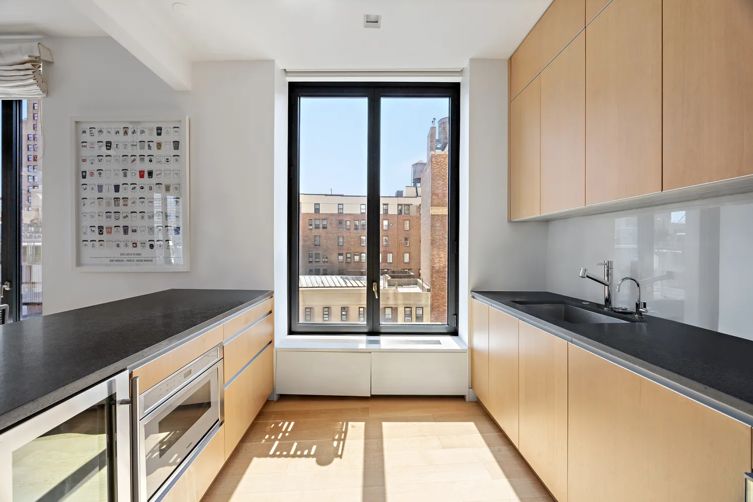 a open kitchen with granite countertop a sink and a stove next to a window