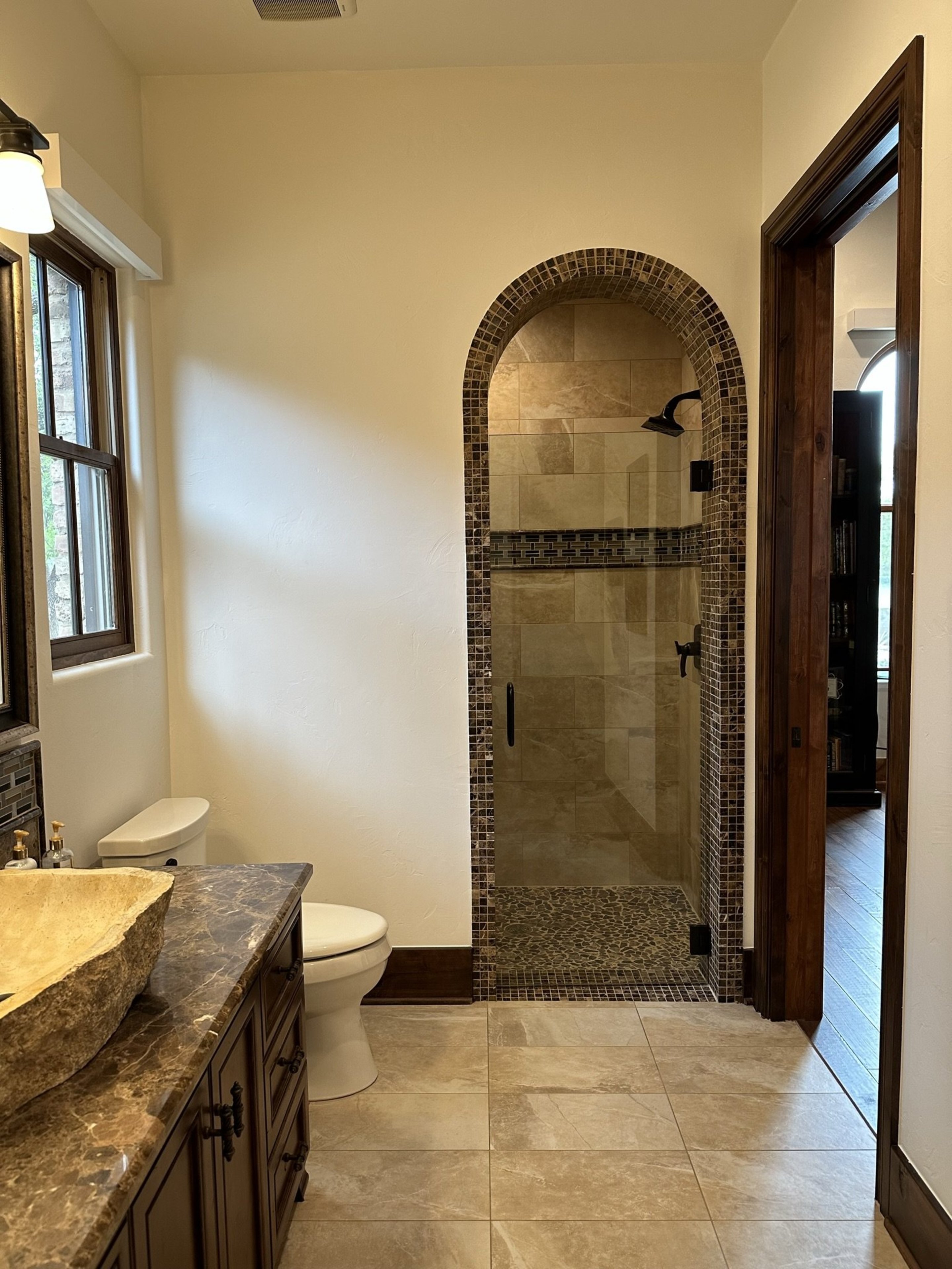 808 Rivercliff Drive Spicewood, TX 78669 - Photo 48 of 71 a bathroom with a granite countertop sink a toilet and shower